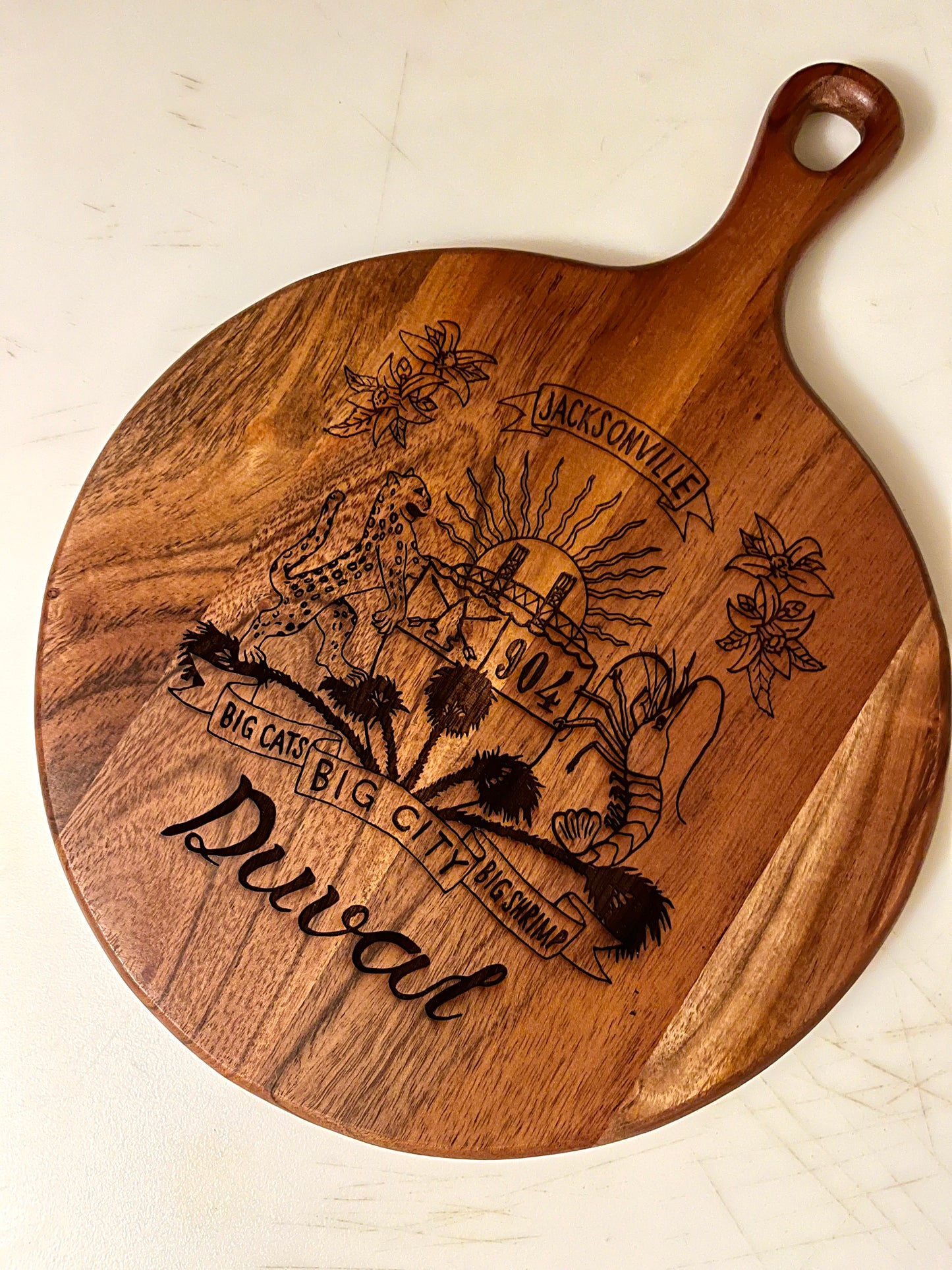 Duval Crest..... Join the Fam!&nbsp;  Show your 904 love at home or at any event with this  Wooden engraved charcuterie board.&nbsp;  10" diameter 3/4' diameter