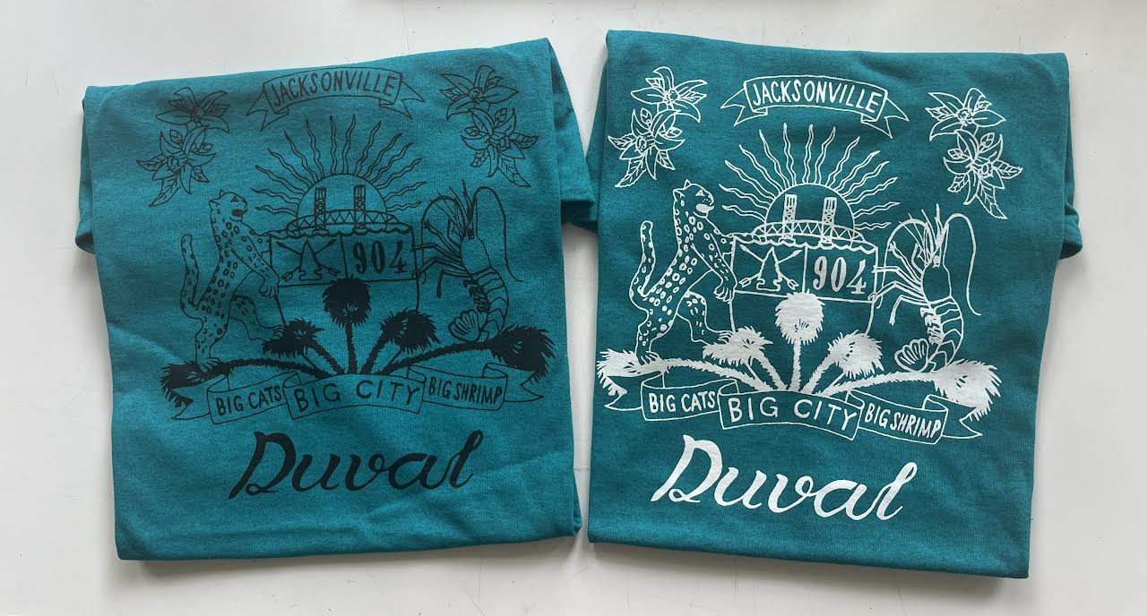 Duval Crest..... Join the Fam!&nbsp;  Show your 904 love with this classic tee.&nbsp;  Locally made&nbsp;t-shirts with&nbsp;glow in the dark (white) or black lettering  &nbsp;Available in sizes S, M, L, XL, XXL, 3XL, and 4XL    .Features    Gildan heavy weight 5.3 oz., 100% preshrunk cotton  Double-needle sleeve and bottom hems Taped neck and shoulders Classic midweight fabric Classic fit tubular body 7/8" collar Classic fit Tear-away label