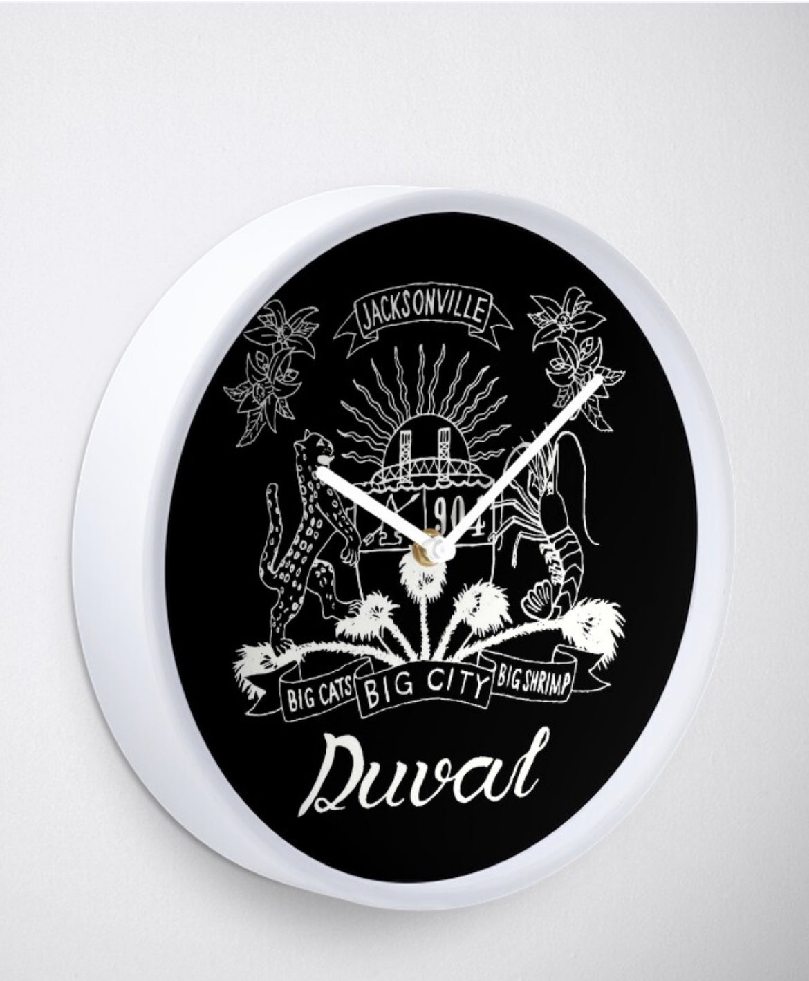 Duval Crest..... Join the Fam!  Connect and show your love for the 904 experience. What time is it? Duval Time.   Product Measurements Depth 2in.  Diameter  10.25in  Product features It's always art o'clock when your clock is a work of art Printed polypropylene face made for you when you order Metal hands in your choice of colors Bamboo wood frame in black, white, or natural finish Quartz clock mechanism for accurate timekeeping Clear plexiglass lens Built-in rear hook, ready to hang AA battery not included