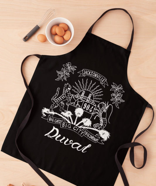 Duval Crest... Join the Fam! Show your love for the 904 while in the kitchen, at the grill, or at the studio!  Product features:  Stay clean in style when you're doing dirty work in the kitchen, in the art studio, in the garden, or at the BBQ All-over sublimation print design 100% polyester Durable neck band and extra-long black ties that wrap around to tie in front One size fits most adults Easy care, machine washable Product Measurements  Width. 25.6 in  Height 31.5 in
