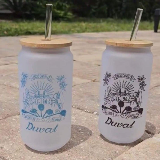 Duval Crest... Join the Fam! Show your love for the 904 while in the kitchen, at the grill, or anywhere!  Want to be ready for Summer 2024's adventures? Stay hydrated, healthy, and classy with our Duval Crest Drinking Jugs!  Made of frosted glass with a wooden seal and glass straw, plastic is now a thing of the past.  Size 16 oz.